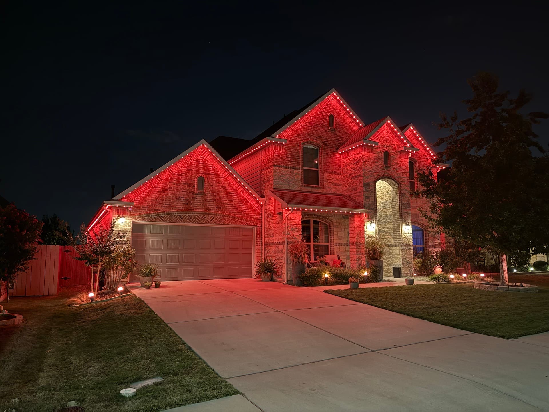 Smart permanent lighting creating a welcoming atmosphere on an Austin home