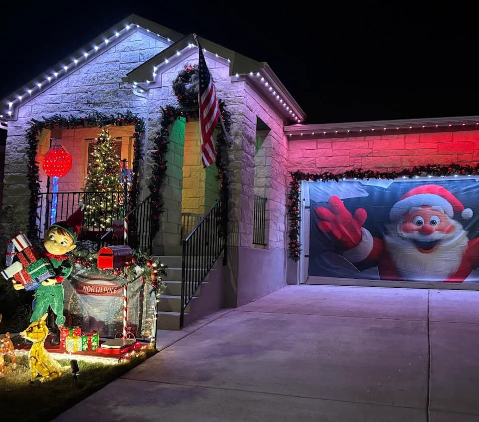 White and red permanent Christmas lighting on a Buda home decorated for the holidays.