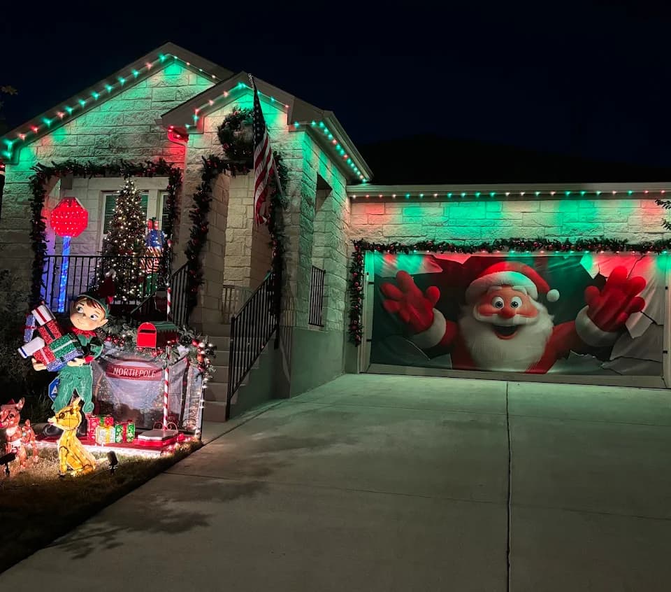 Red and green permanent Christmas lighting on a Buda home decorated for the holidays.