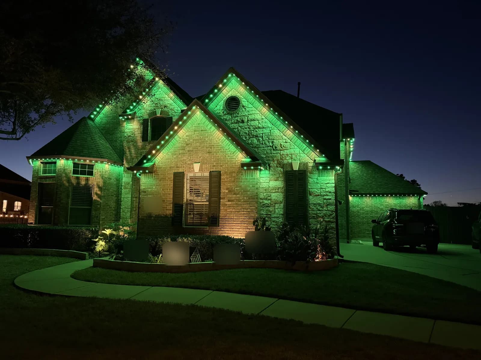Green and gold St. Patrick's Day lighting on a Round Rock home.