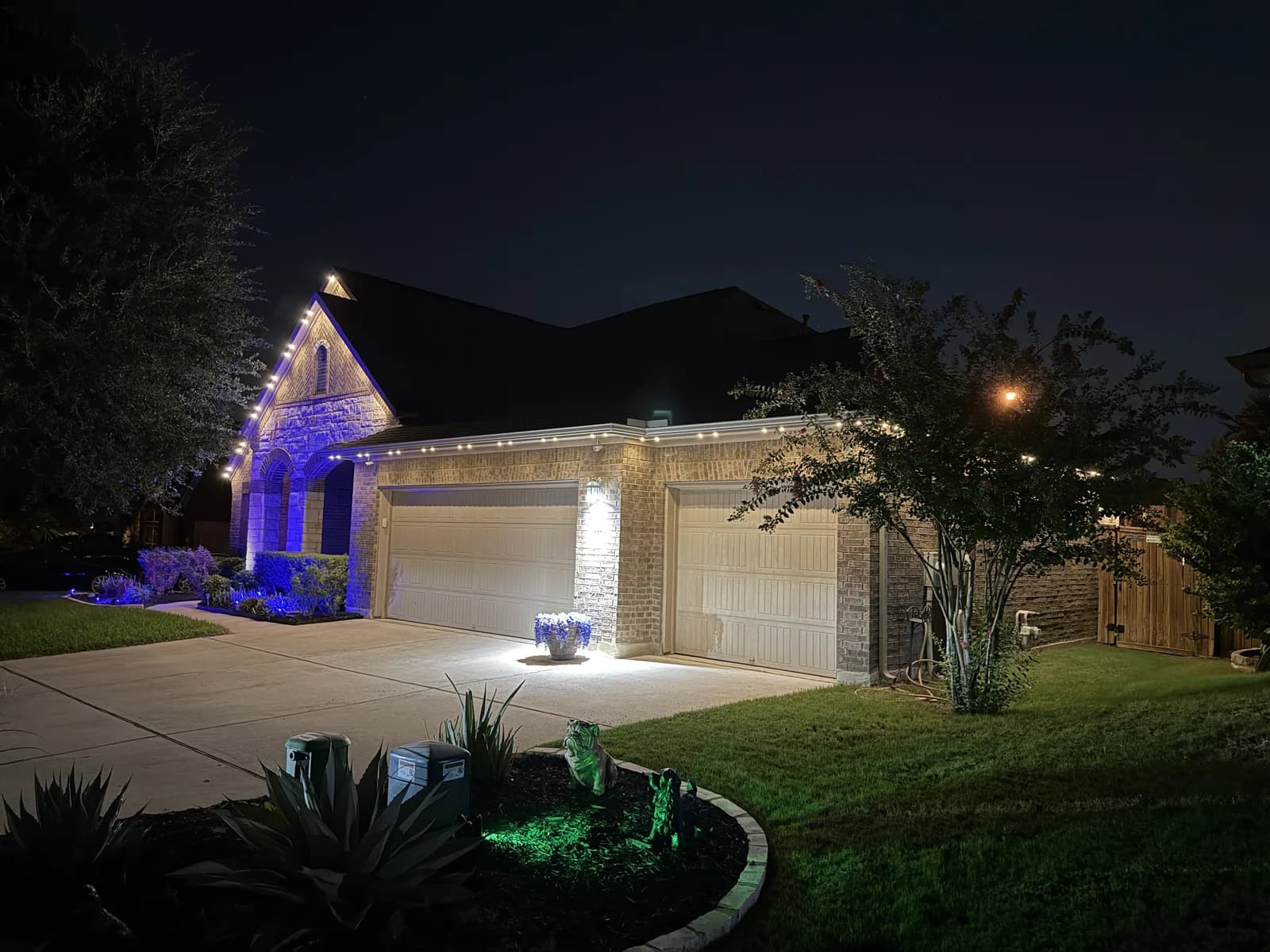 Warm white accent lighting on a brick home in Round Rock.