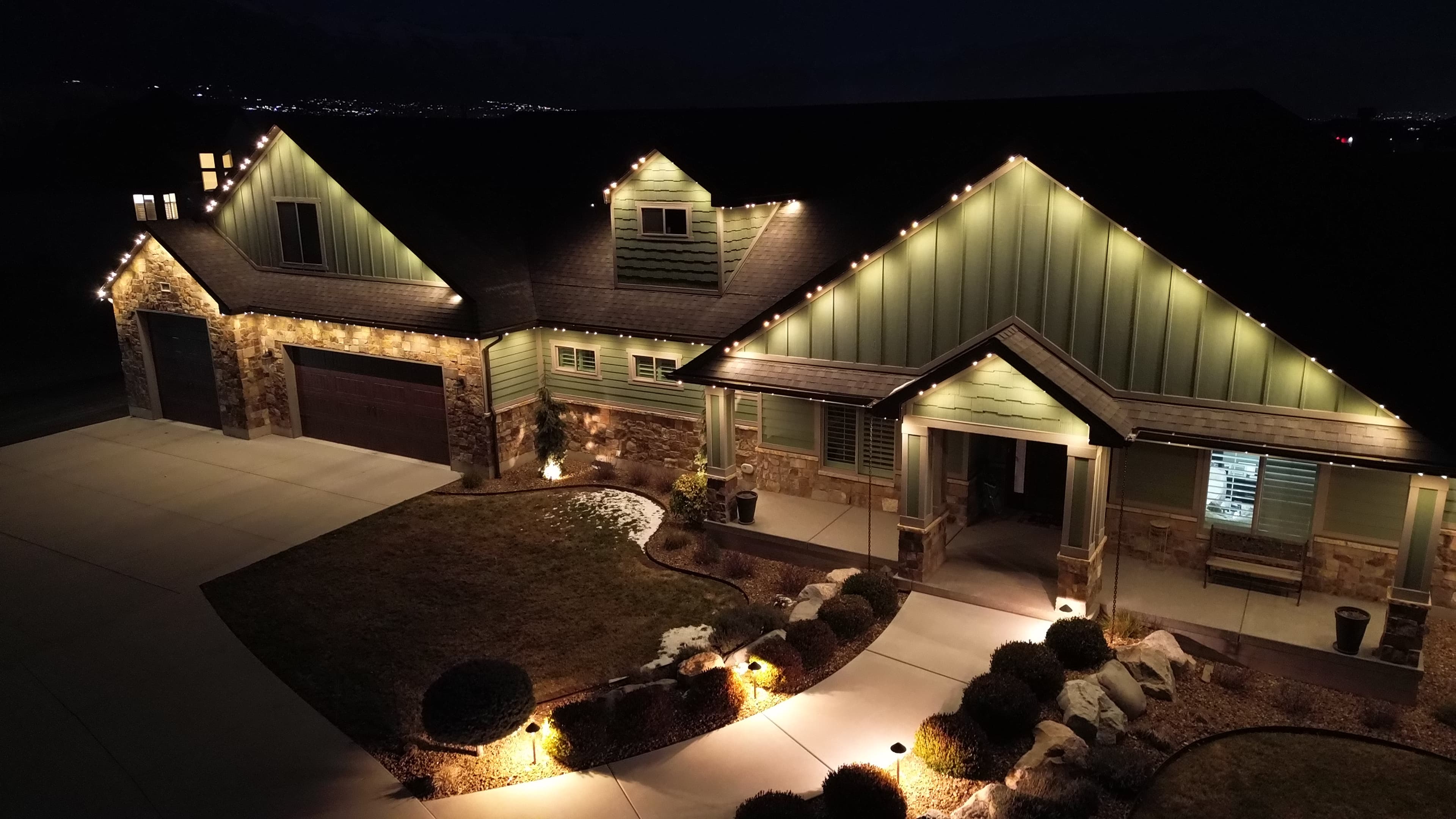 Permanent LED roofline lighting glowing at dusk on a Cibolo family home