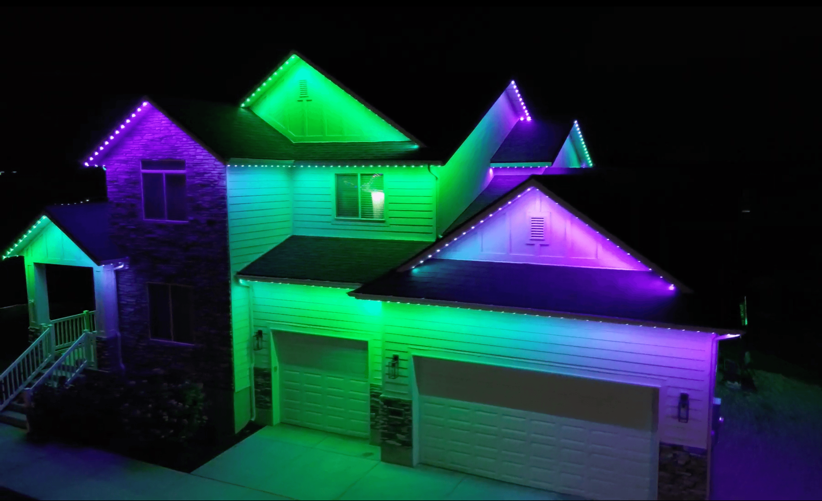 Permanent holiday lighting displaying orange and purple for Halloween on an Austin home