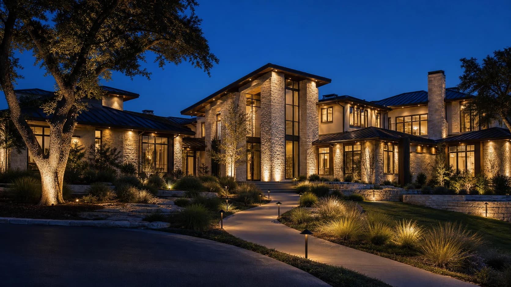 Warm-white landscape lighting on a fictional luxury Hill Country estate