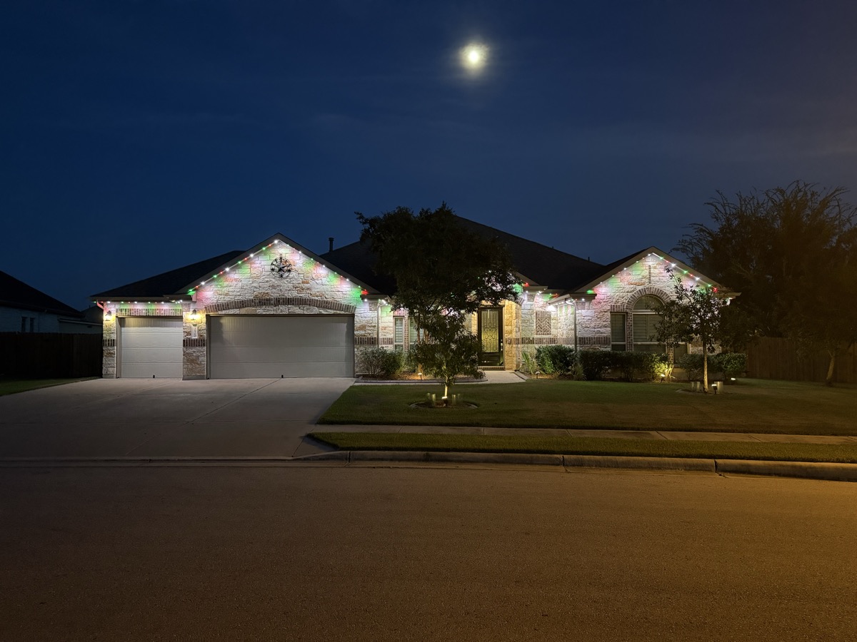 Well-designed permanent lighting highlighting architecture on an Austin Hill Country home