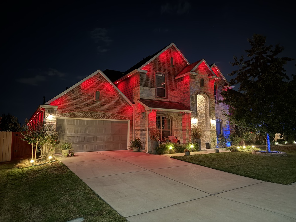 Clean permanent LED lighting with hidden track on a large Austin home at night