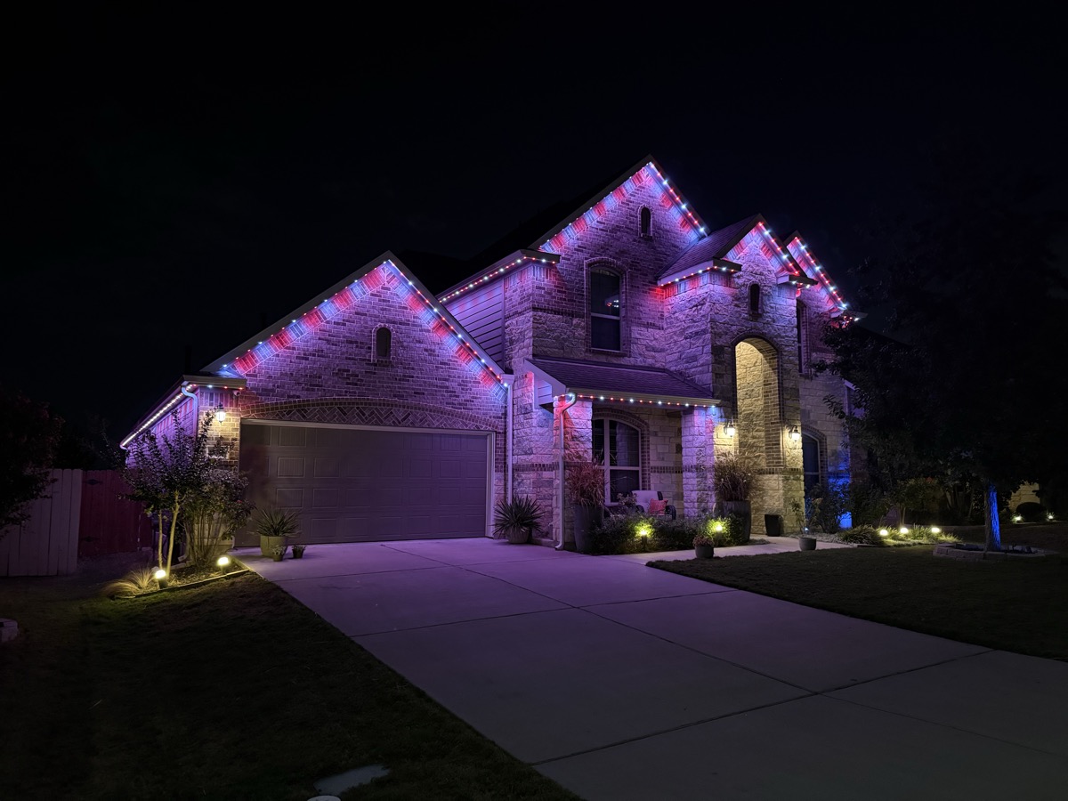 Custom outdoor lighting creating backyard ambiance on an Austin home